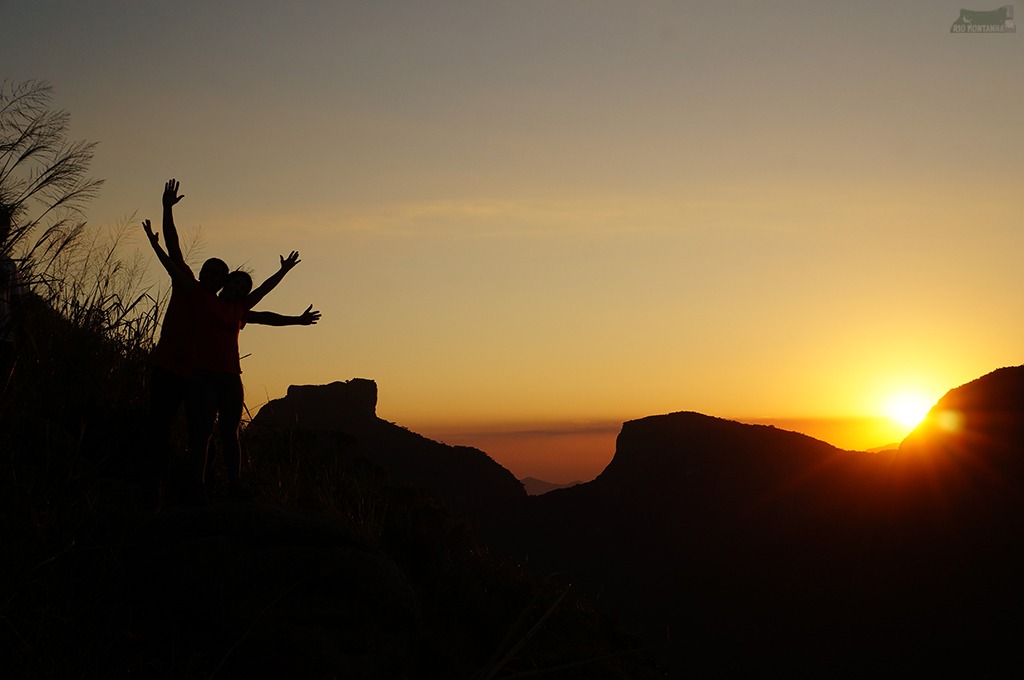 Couple seen in the shadows of a sunrise during the Dois Irmãos Hike.